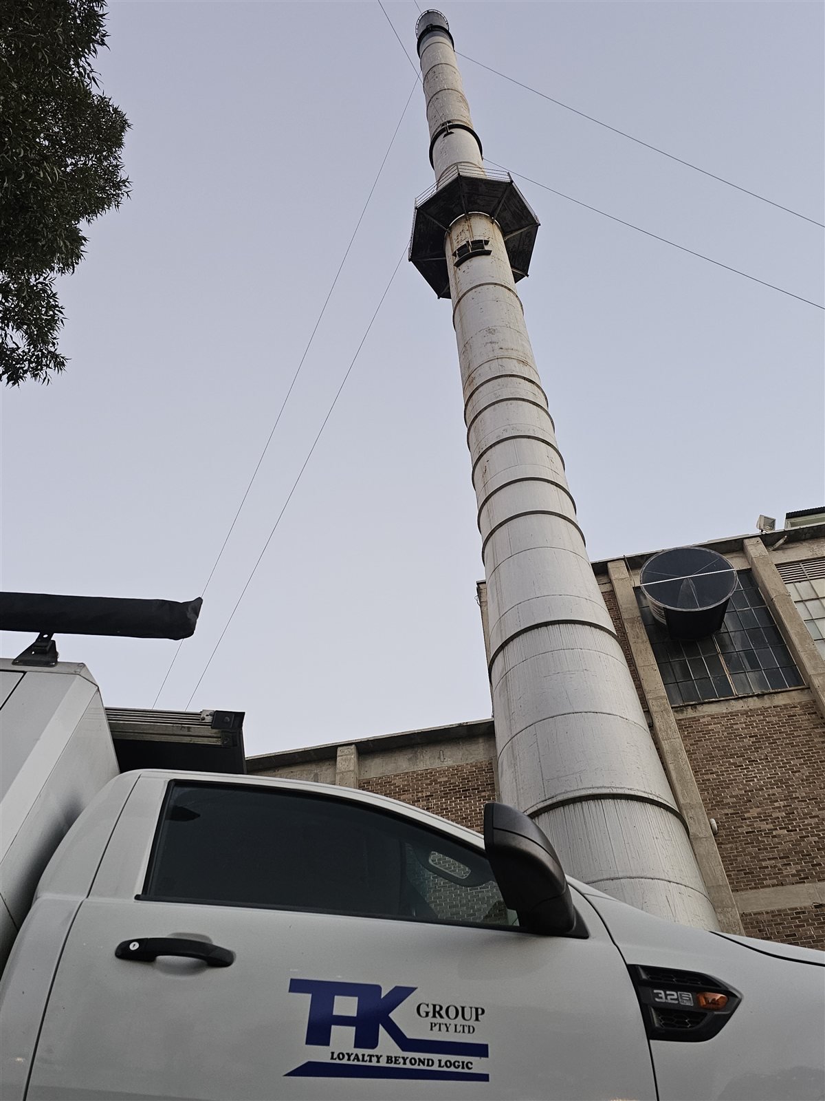 The heritage powerhouse chimney with the TAK Industrial ute on site