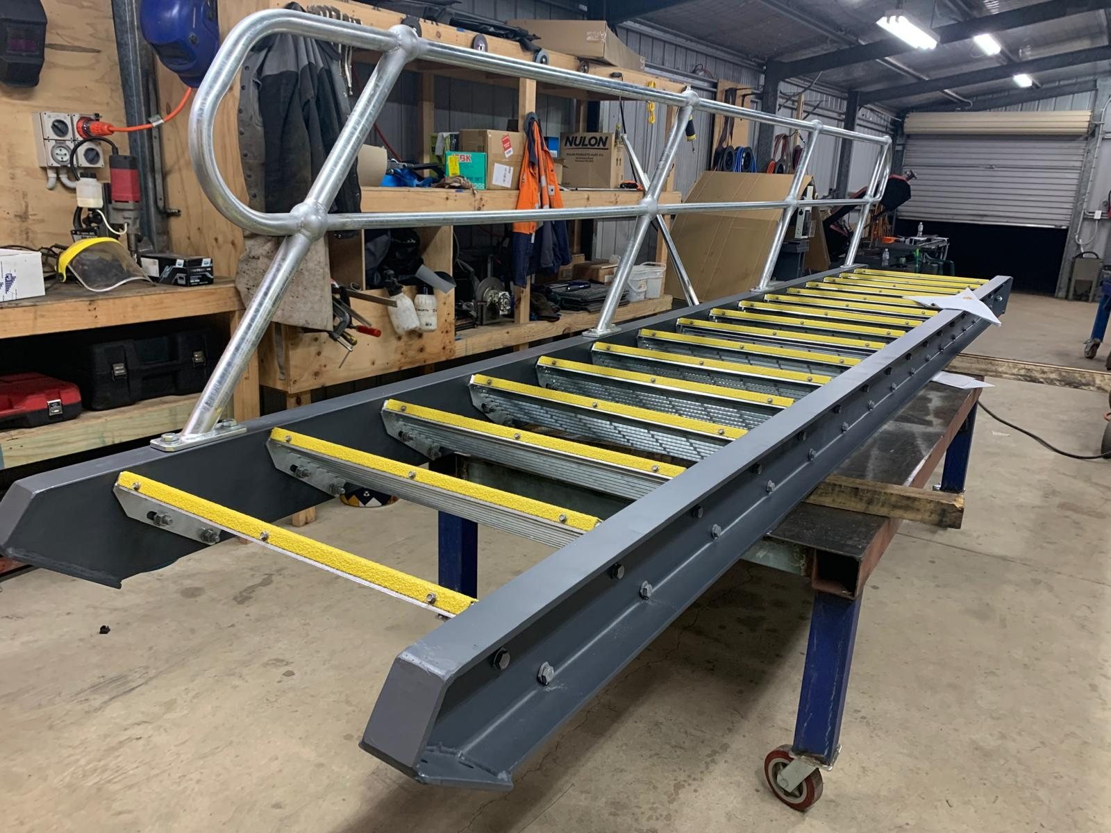 Steel stair with mesh treads and yellow nosings